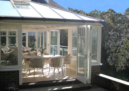 Folding Sliding Doors open this Conservatory onto a terrace in Wimbledon