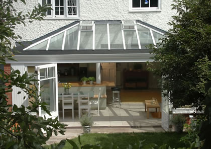 Wide opening doors lead from conservatory kitchen extension in near Richmond South West London