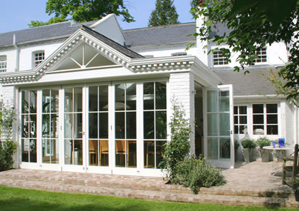 Garden room with folding sliding doors in Wimbledon